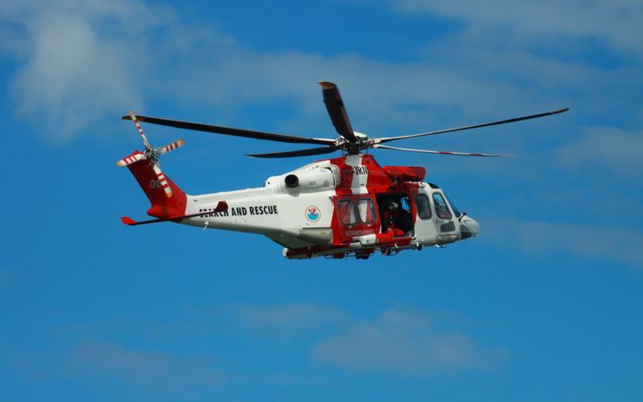 Rescue helicopter flying in a blue sky