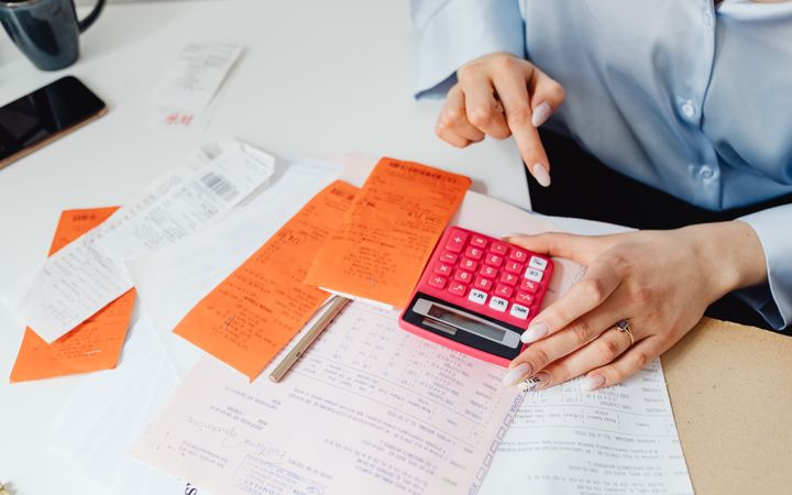 Receipts and a calculator on a desk
