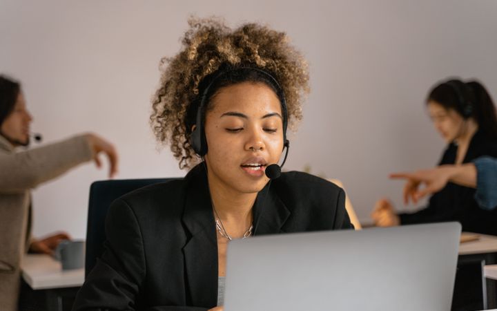 Insurance agent with a headset helping a customer