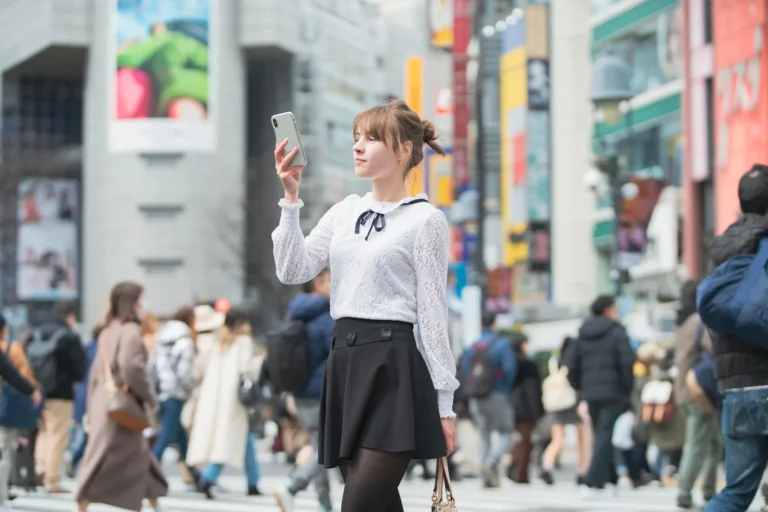 Traveler using her smartphone in Shibuya, Tokyo